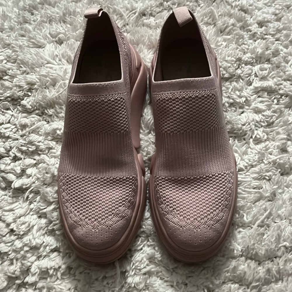 Pink slip on tennis shoes.